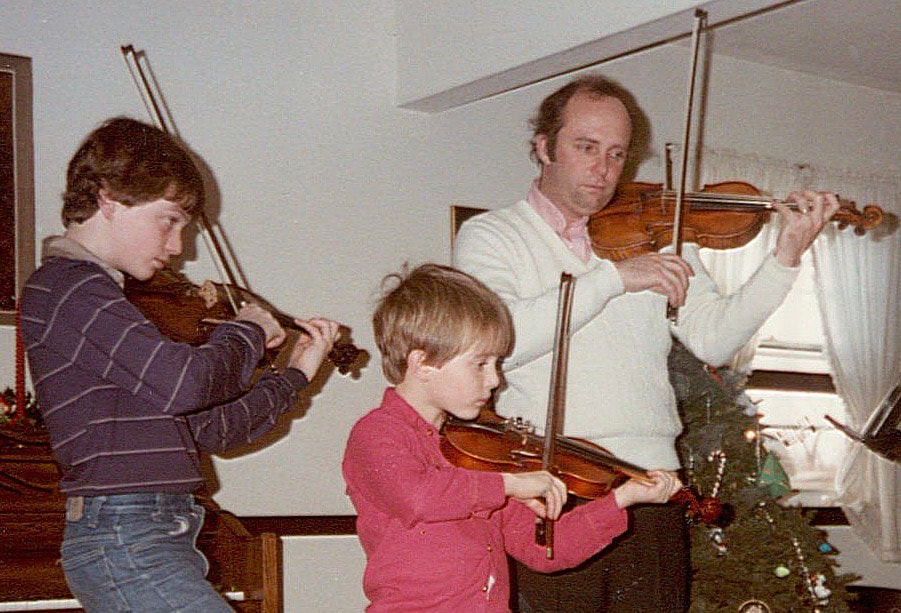 Garrett Fischbach as a child playing violin with family